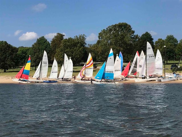Beach full catamarans on Washington Irving South Beach, dand, very colorful sails still erected, 20 boats